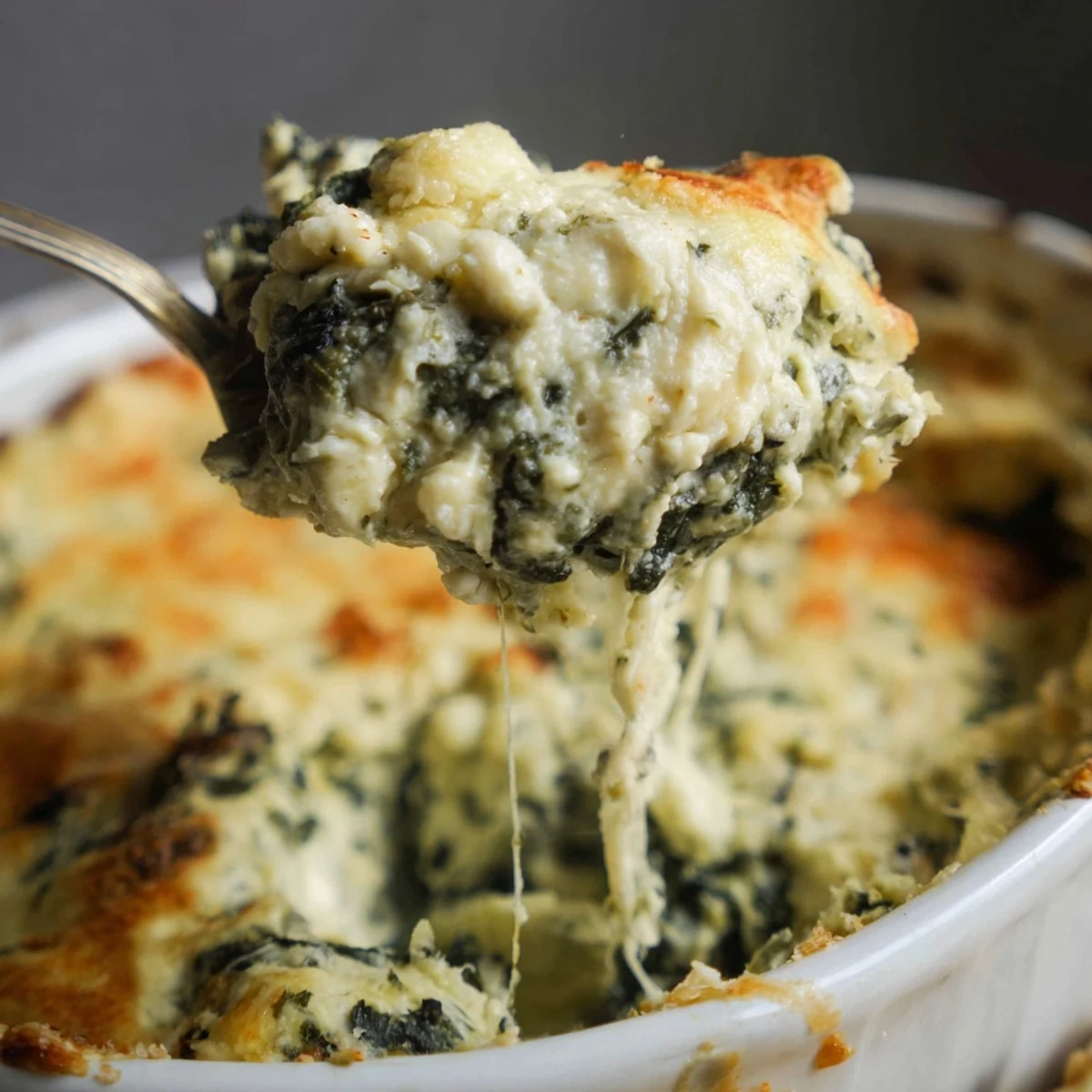 Warm spinach and artichoke dip, a bubbling, cheesy appetizer perfect for dipping crusty bread.