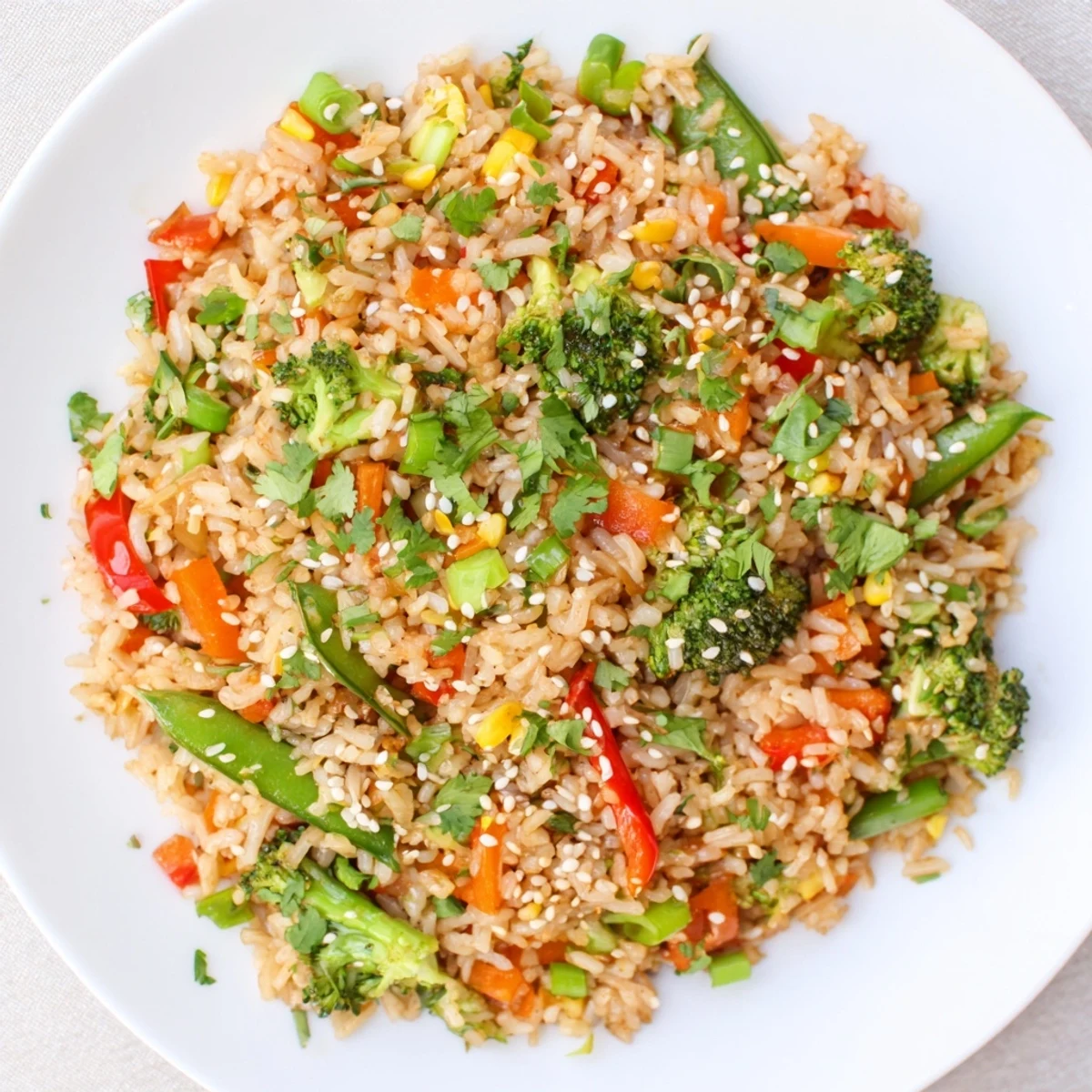 A golden, crispy bed of Crispy Vegetable Fried Rice Bowls, overflowing with colorful sautéed veggies.
