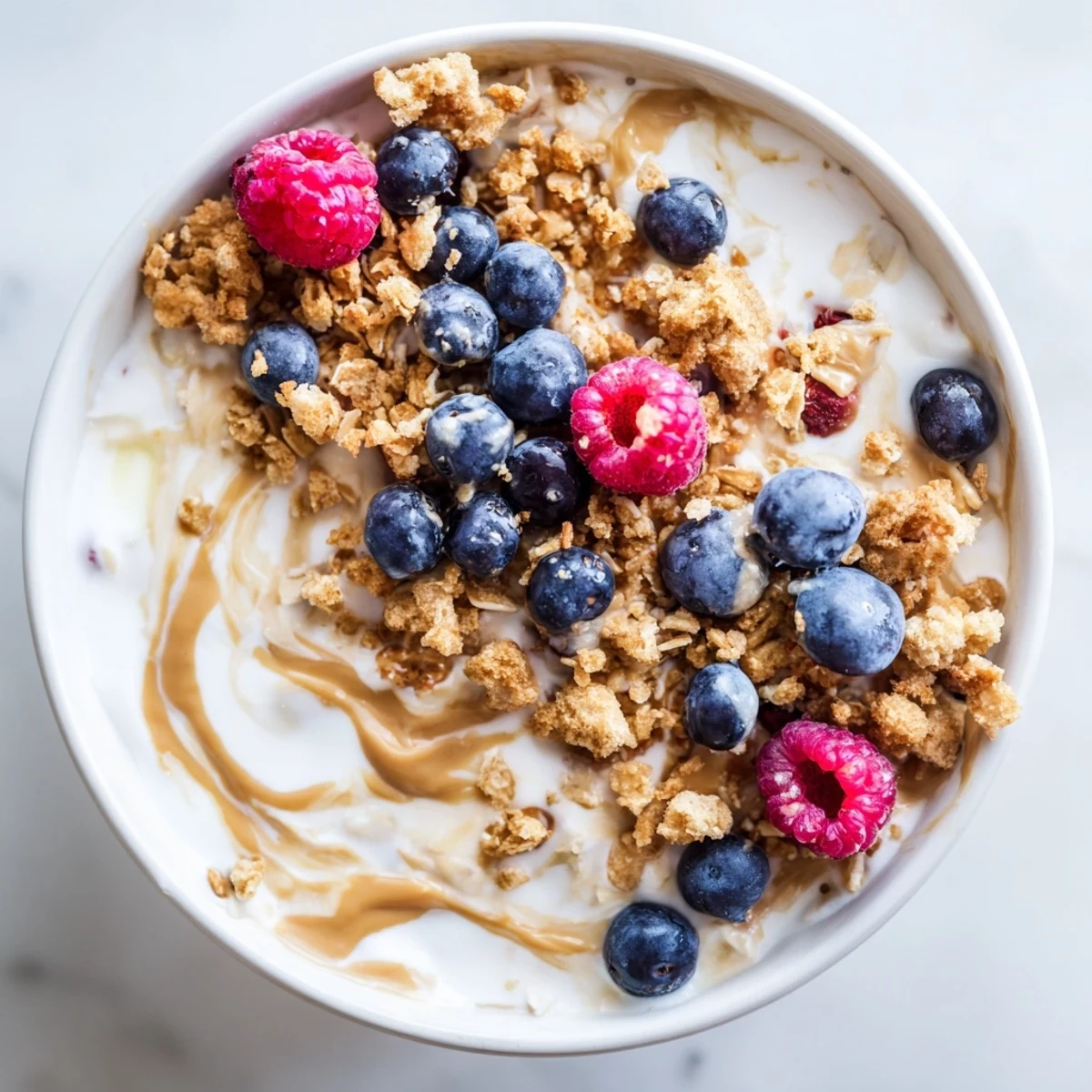 Close-up of overnight oats gourmet makeover, creamy textures swirled with nut butter and berries.