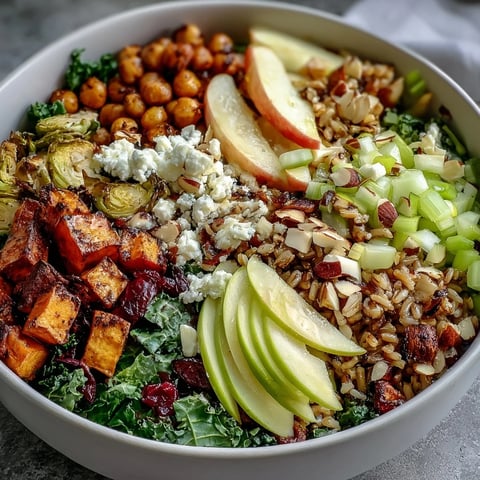 Fall Harvest Bowl with roasted sweet potatoes, Brussels sprouts, and kale topped with almonds and feta.