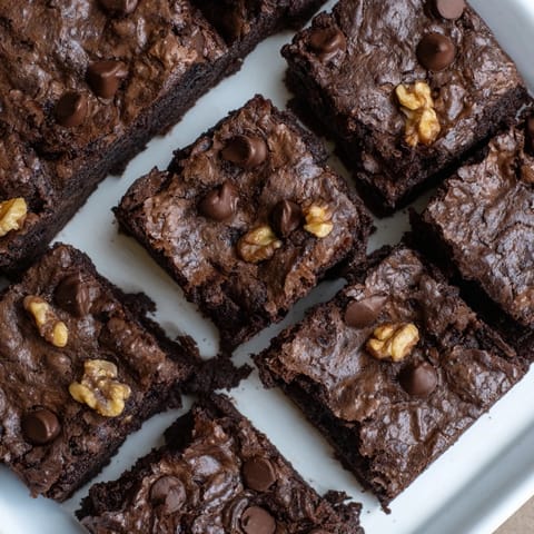 Warm, gooey fudgy walnut brownies: imagine the aroma of freshly baked, perfectly textured treats.