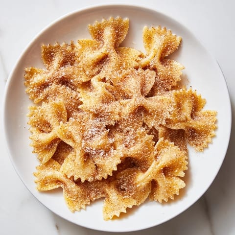 Bowtie pasta transformed into delicious Air Fryer Pasta Christmas Crack, coated with cinnamon sugar.