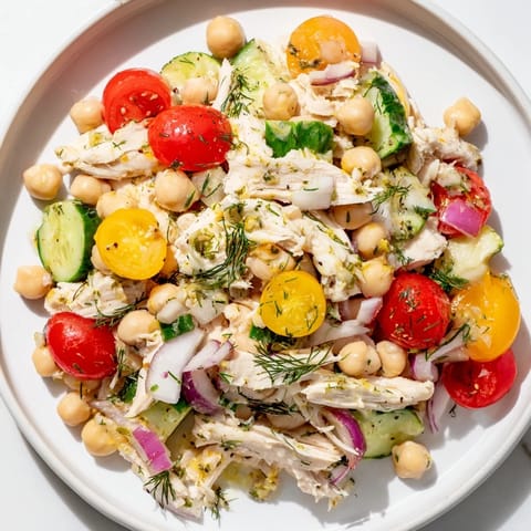 Freshly tossed Dense Bean Salad with Lemon-Dill Chicken, featuring shredded chicken and vibrant vegetables.