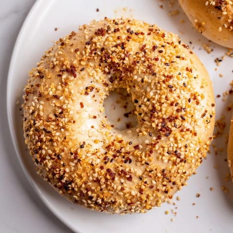 Golden-brown everything bagel yogurt bagels, oven-fresh and sprinkled with flavorful seasoning, perfect breakfast.