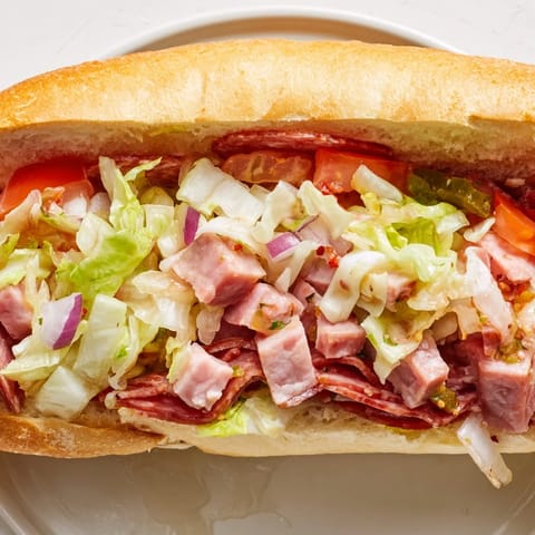 Freshly made Chopped Italian Grinder Sandwich with diced meats and veggies piled high on a sub roll.