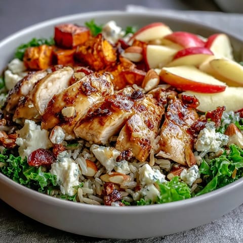 Vibrant Harvest Bowl topped with crisp apples, creamy goat cheese, and tangy balsamic dressing.