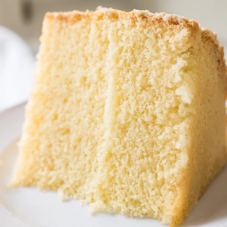 This simple vanilla sponge cake showcases a light, airy texture, perfect for any occasion's dessert table.