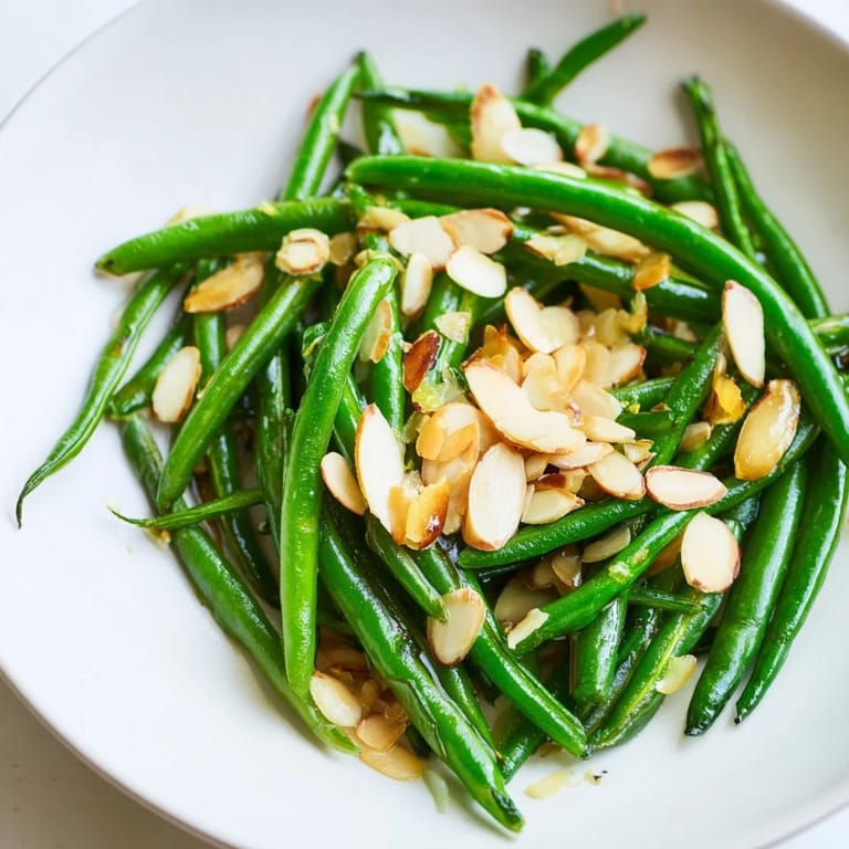 A close-up view of Sautéed Green Beans with Garlic and Almonds, showing a perfect, flavorful dish.