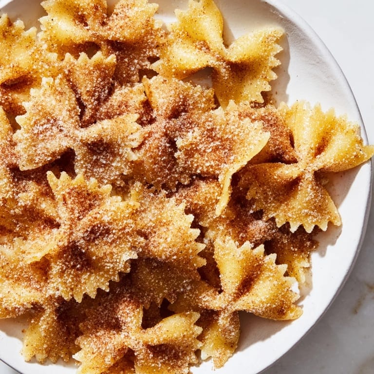 Close-up of freshly made Air Fryer Pasta Christmas Crack: crunchy, cinnamon-dusted bites perfect for sharing.