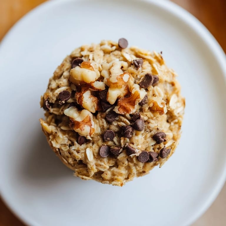 Warm, hearty Baked Oatmeal Cups studded with berries, ready to enjoy alongside a cup of coffee.