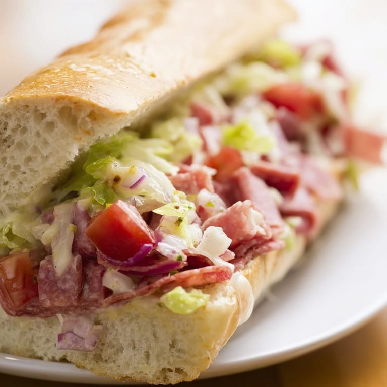 A hearty Chopped Italian Grinder Sandwich, ready to serve, showcasing a colorful mix of Italian ingredients.