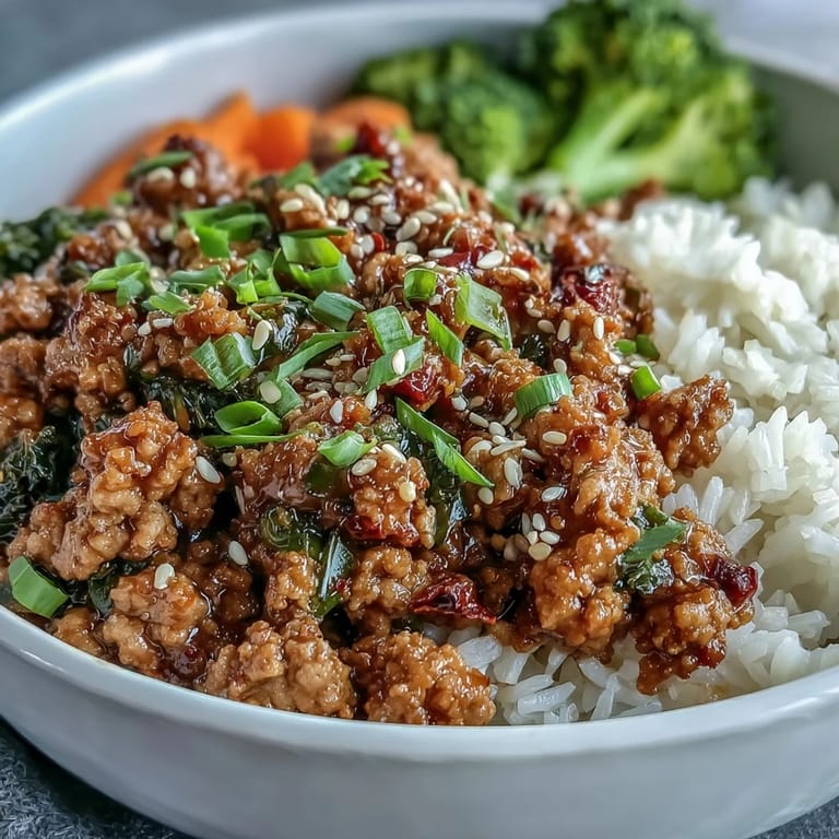 Spoon serving Korean-Style Ground Turkey over steamed rice with sautéed broccoli for a complete, protein-packed weeknight dinner.