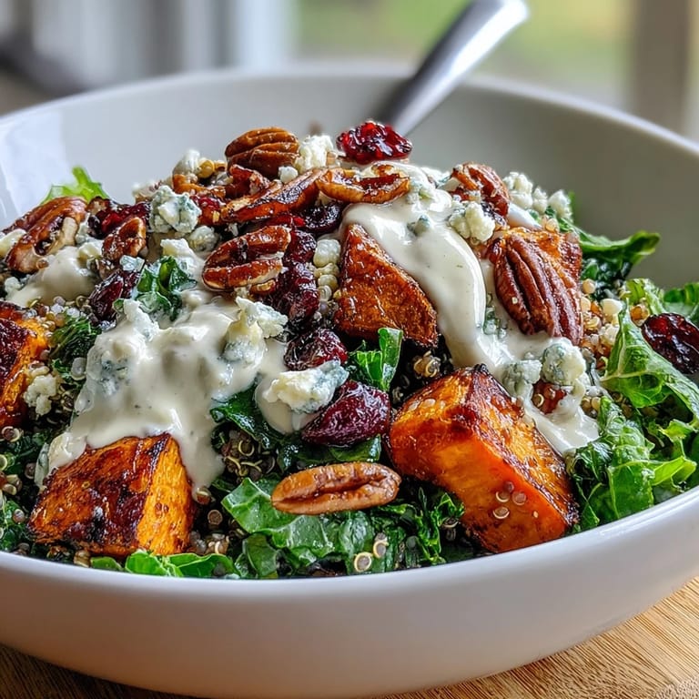 Fork-ready Harvest Kale Quinoa Bowl with crunchy pecans, sweet cranberries, and tangy blue cheese on a rustic wooden board.